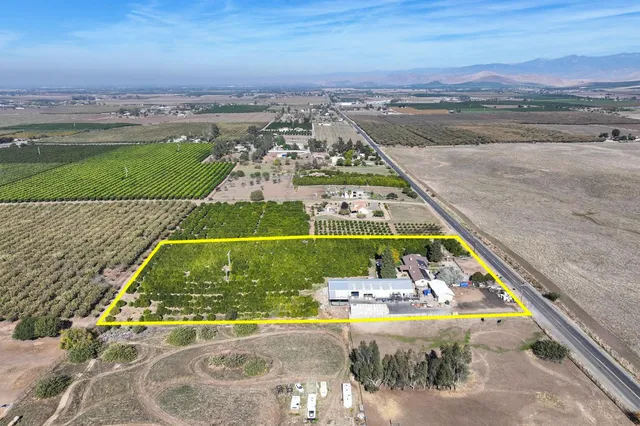 an aerial view of a residential houses with outdoor space