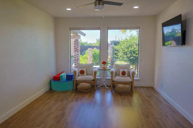 a living room with furniture and a wooden floor