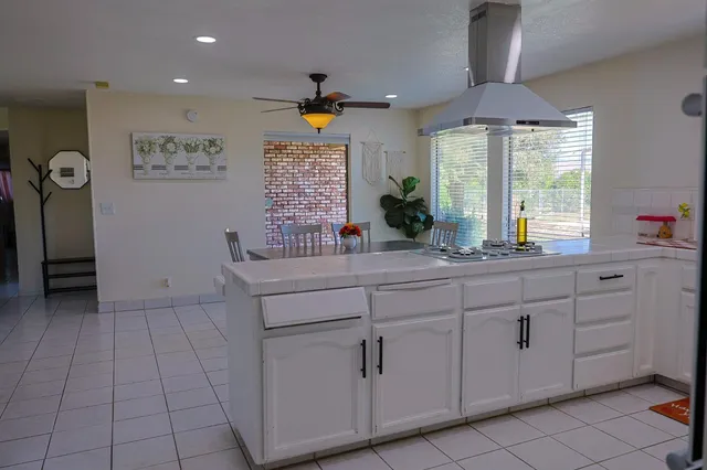a kitchen with cabinets and window