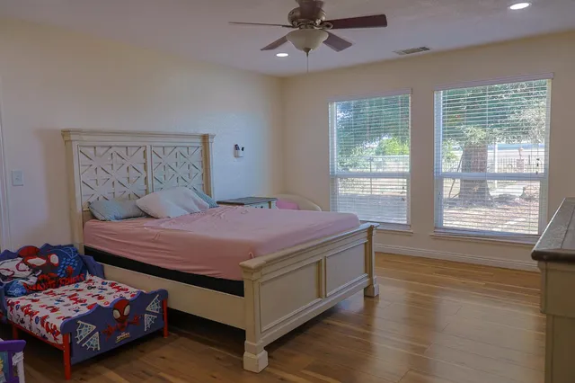 a bedroom with a bed and a large window