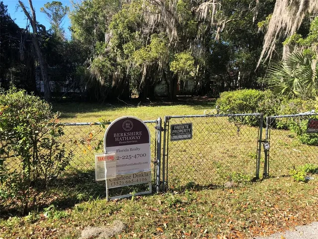 a view of a bench in backyard of house