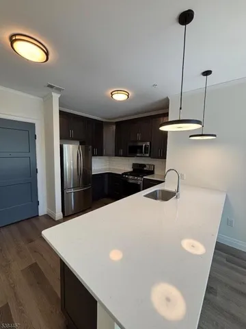 a kitchen with stainless steel appliances kitchen island a refrigerator sink and stove