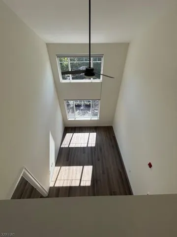 an empty room with a empty space and windows