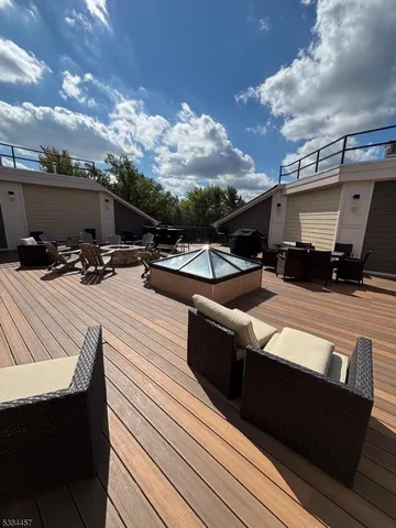 a view of a roof deck with couches and sky view