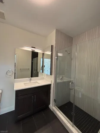 a bathroom with a double vanity sink toilet and shower