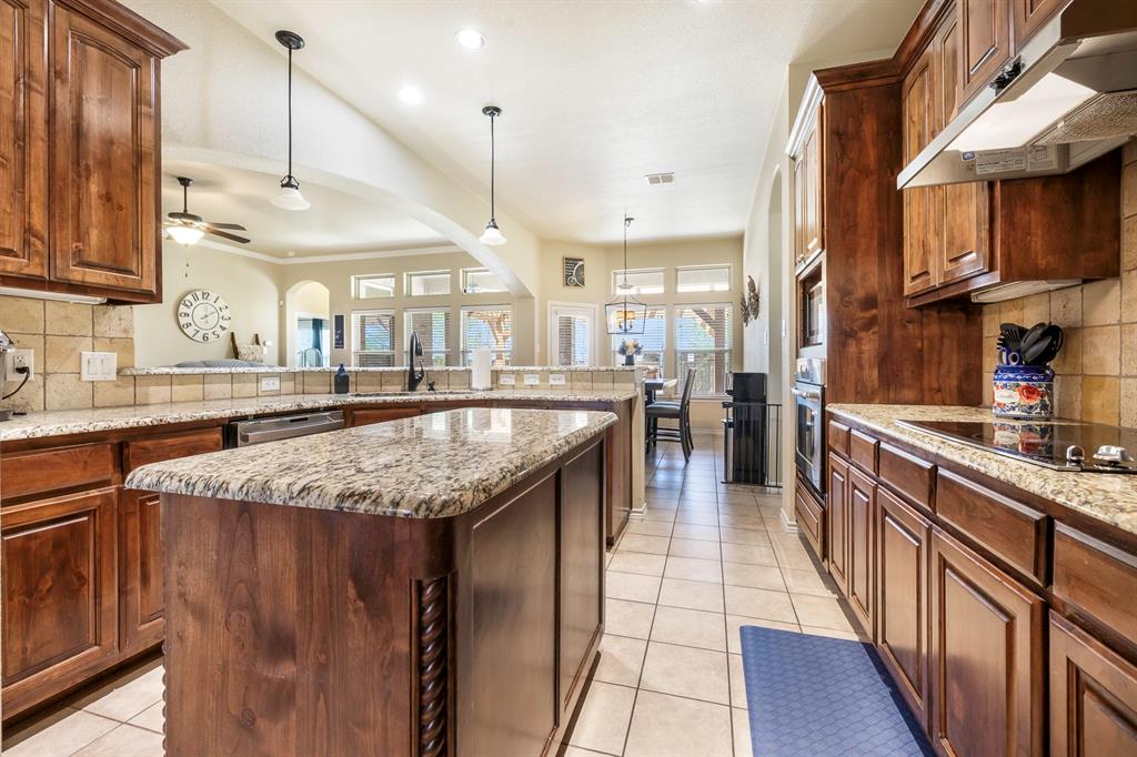 103 Brandy Lane Stephenville, TX 76401 - Photo 11 of 37 a kitchen with stainless steel appliances granite countertop a sink a stove and a wooden floors