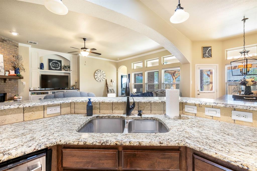 103 Brandy Lane Stephenville, TX 76401 - Photo 12 of 37 a kitchen with granite countertop a sink and a counter top space