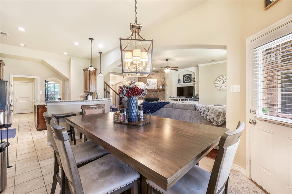 103 Brandy Lane Stephenville, TX 76401 - Photo 14 of 37 a dining room with wooden floor a chandelier a wooden table and chairs