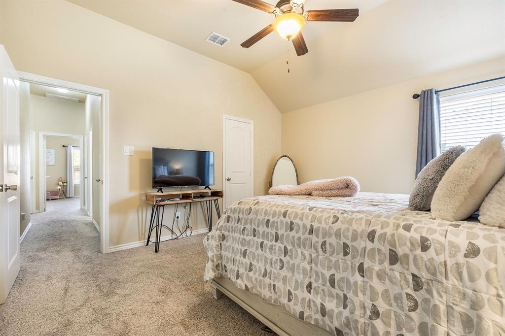103 Brandy Lane Stephenville, TX 76401 - Photo 19 of 37 a bedroom with a bed and a flat screen tv