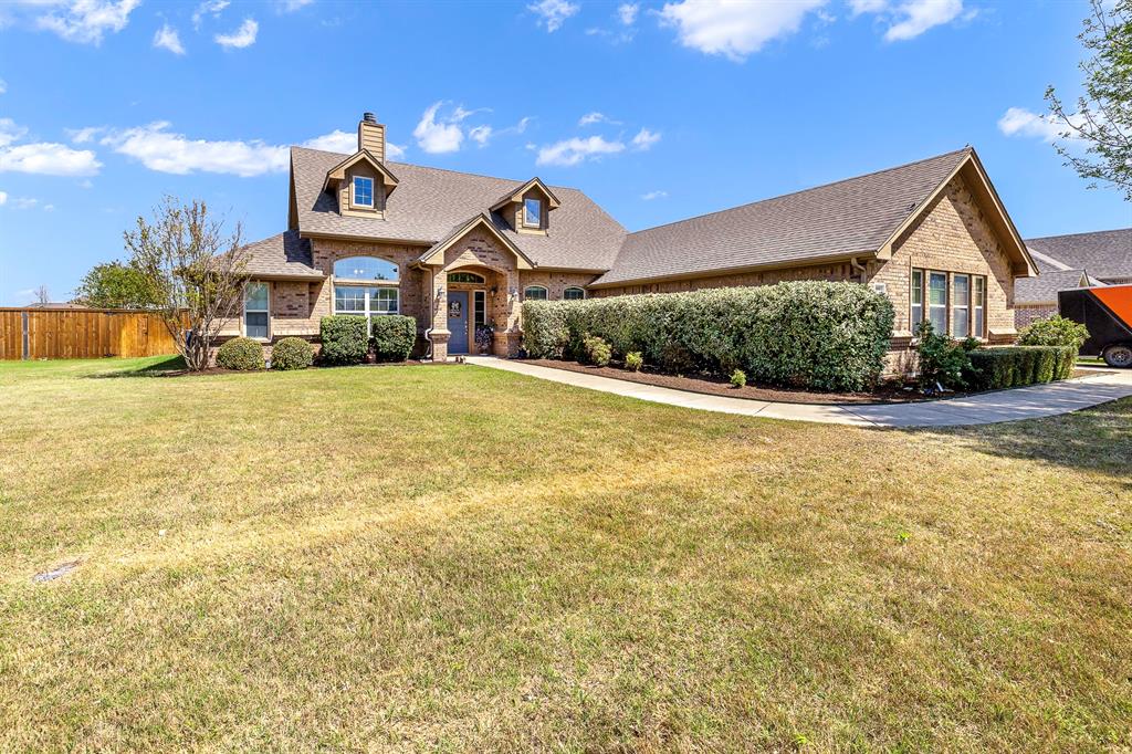 103 Brandy Lane Stephenville, TX 76401 - Photo 2 of 37 a front view of a house with a yard and potted plants