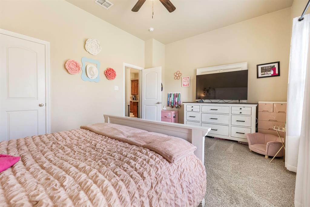 103 Brandy Lane Stephenville, TX 76401 - Photo 22 of 37 a bedroom with a bed and a flat screen tv