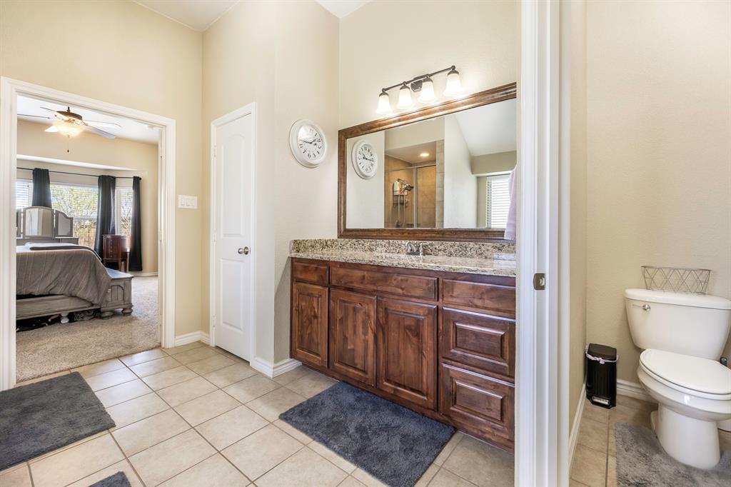 103 Brandy Lane Stephenville, TX 76401 - Photo 27 of 37 a en suite bathroom with a granite countertop sink and a mirror