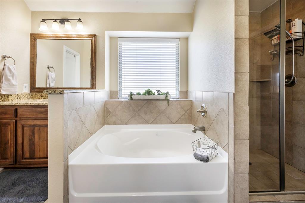103 Brandy Lane Stephenville, TX 76401 - Photo 28 of 37 a bathroom with a bathtub and a shower
