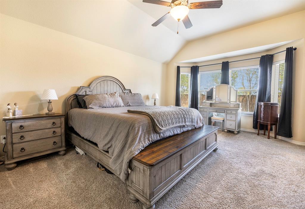 103 Brandy Lane Stephenville, TX 76401 - Photo 30 of 37 a spacious bedroom with a bed and a chandelier