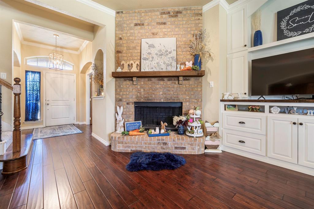 103 Brandy Lane Stephenville, TX 76401 - Photo 7 of 37 a living room with furniture a flat screen tv and a fireplace