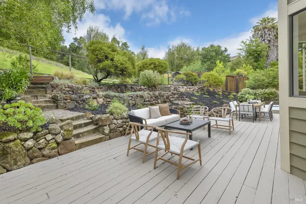 a view of a backyard with sitting area