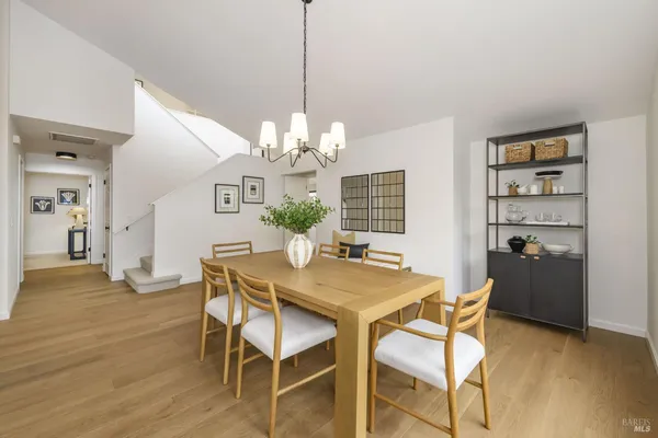 a view of a dining room with furniture and chandelier