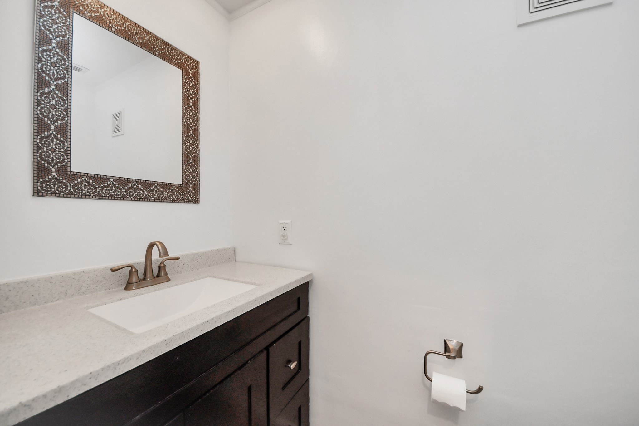 7447 Cambridge Street, Unit 106 Houston, TX 77054 - Photo 16 of 40 a bathroom with a sink and a mirror