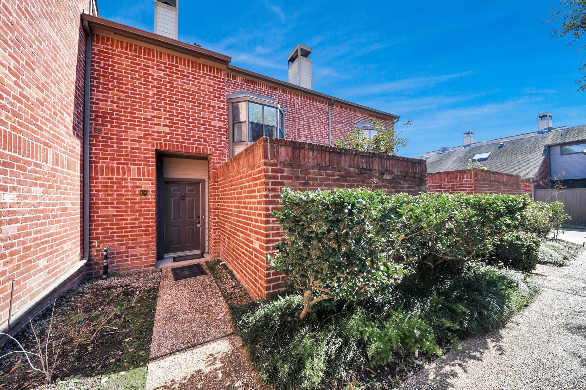 7447 Cambridge Street, Unit 106 Houston, TX 77054 - Photo 2 of 40 a front view of a house with a yard