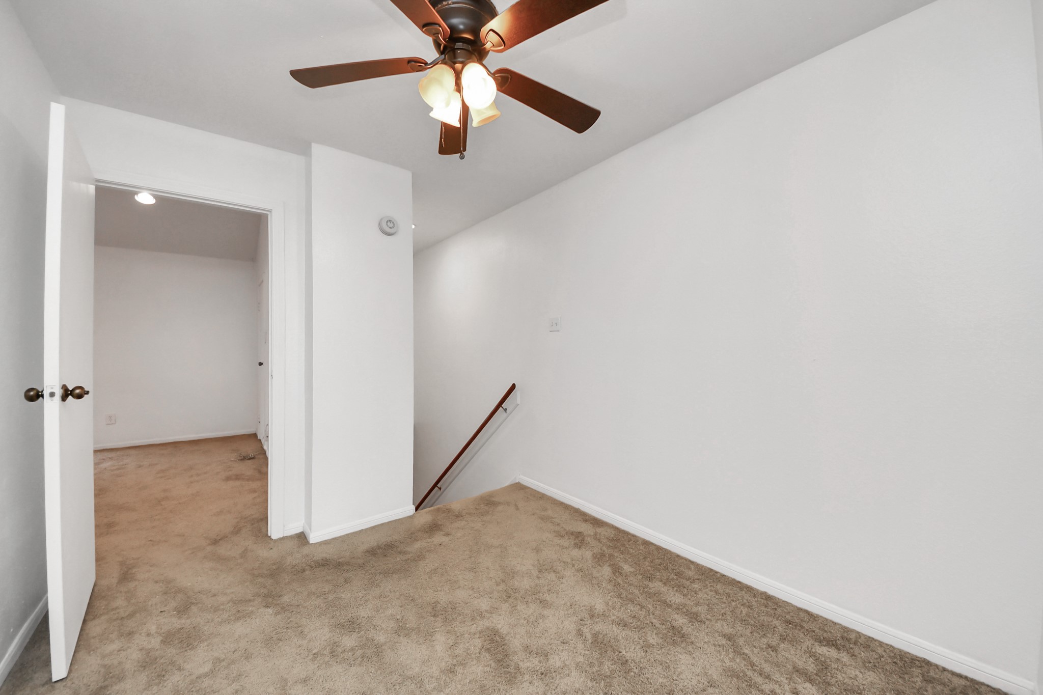 7447 Cambridge Street, Unit 106 Houston, TX 77054 - Photo 24 of 40 an empty room with a ceiling fan and carpet