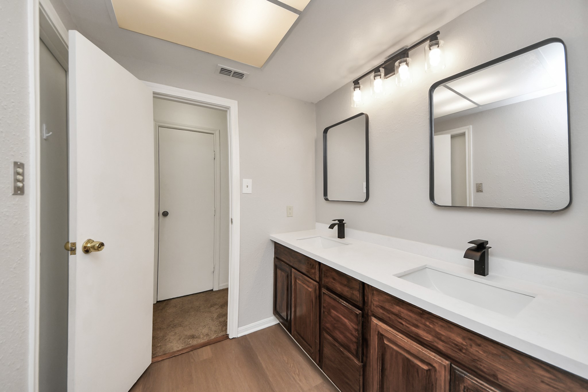 7447 Cambridge Street, Unit 106 Houston, TX 77054 - Photo 30 of 40 a bathroom with a double vanity sink and mirror