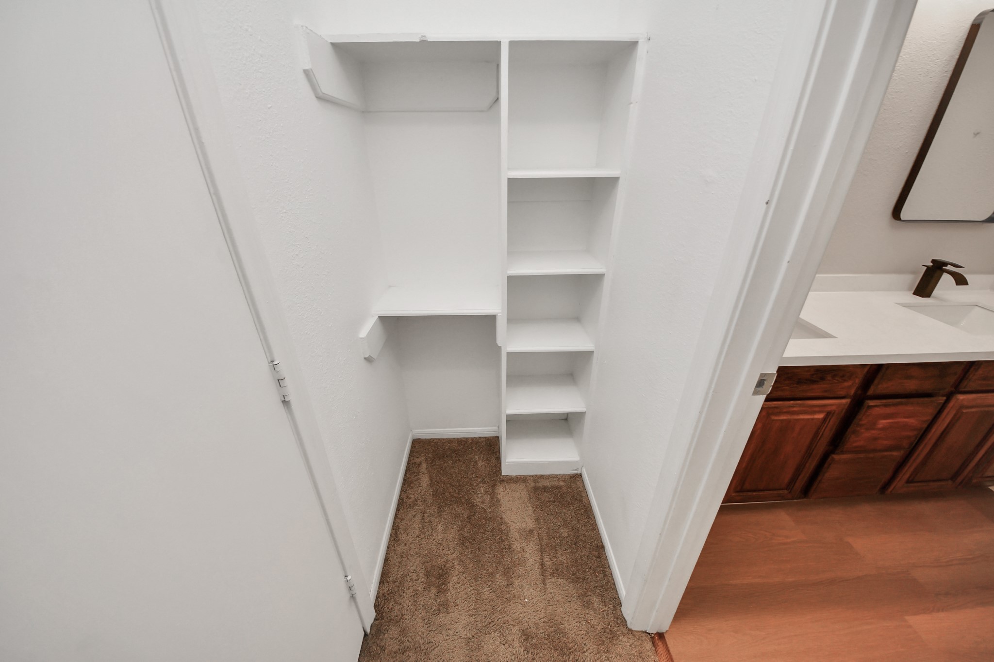 7447 Cambridge Street, Unit 106 Houston, TX 77054 - Photo 37 of 40 a view of walk in closet with empty racks
