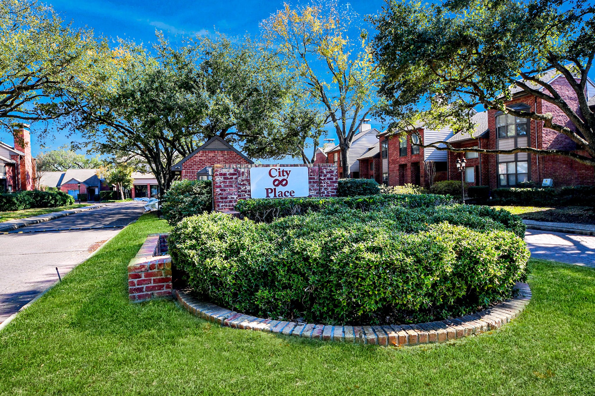 7447 Cambridge Street, Unit 106 Houston, TX 77054 - Photo 38 of 40 a view of a garden with a building in the background