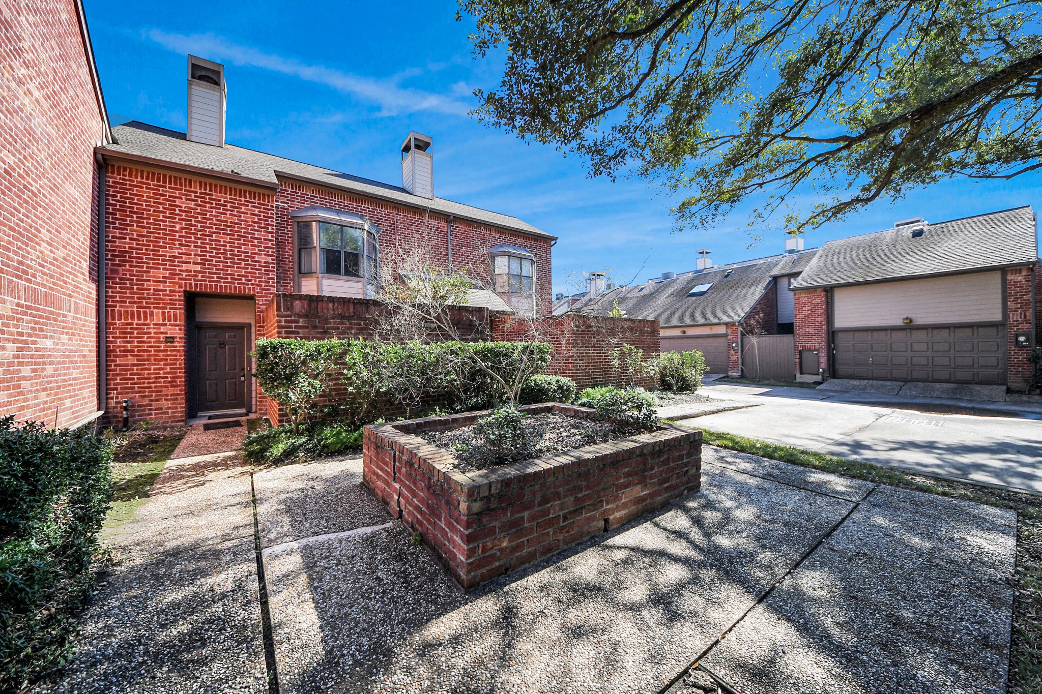 7447 Cambridge Street, Unit 106 Houston, TX 77054 - Photo 8 of 40 a front view of a house with garden