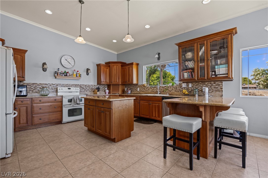 750 Leming Avenue Overton, NV 89040 - Photo 21 of 82 This kitchen features rich cabinetry, practical tile flooring, and ample natural light, ideal for daily living.