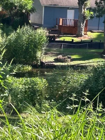 a view of house with swimming pool