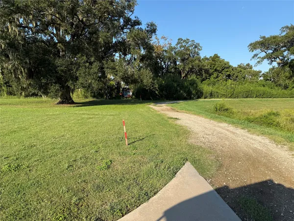 a view of a field with an trees
