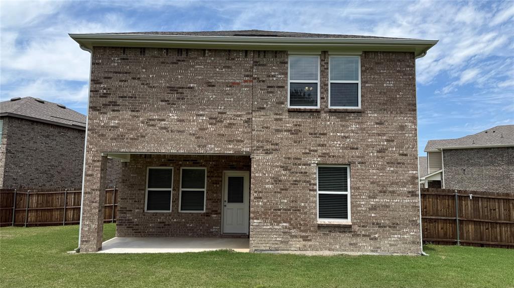 4529 Winecup Road Melissa, TX 75454 - Photo 27 of 29 Two-story brick exterior with a ground-level covered patio and a white rear entry door