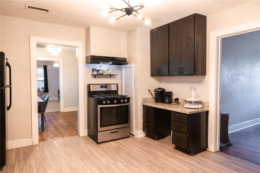 1902 Miller Avenue Bryan, TX 77801 - Photo 12 of 45 a kitchen with stainless steel appliances kitchen island granite countertop a stove and a refrigerator