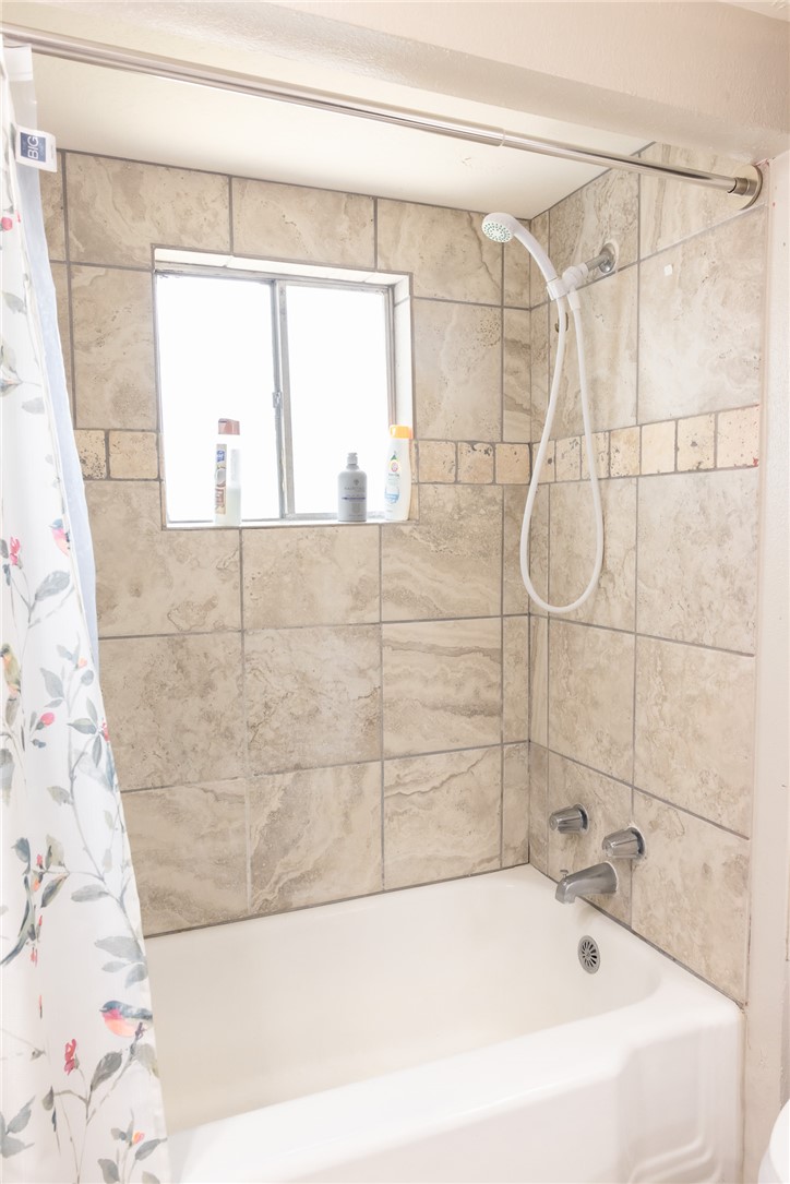 1902 Miller Avenue Bryan, TX 77801 - Photo 17 of 45 a bathroom with a bathtub and shower