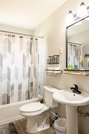a bathroom with a sink toilet a mirror and shower