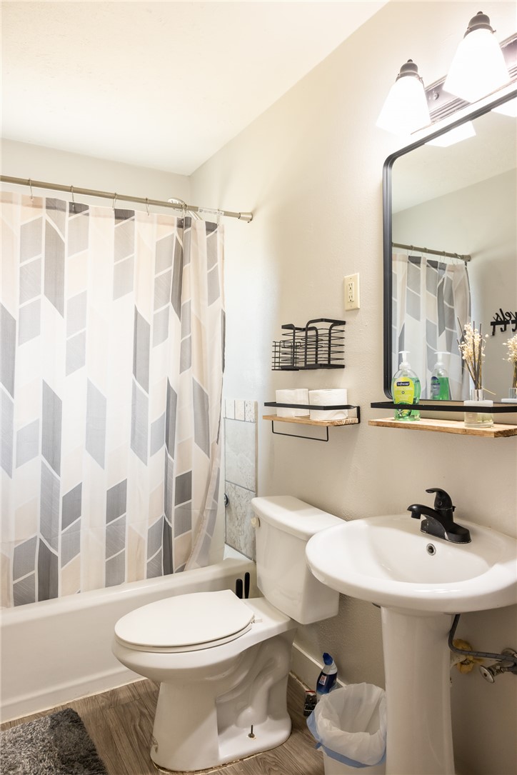 1902 Miller Avenue Bryan, TX 77801 - Photo 20 of 45 a bathroom with a sink toilet a mirror and shower