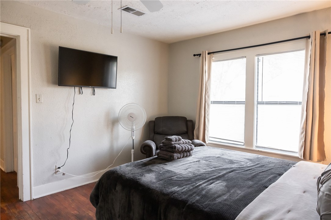1902 Miller Avenue Bryan, TX 77801 - Photo 23 of 45 a bedroom with a bed tv and a window