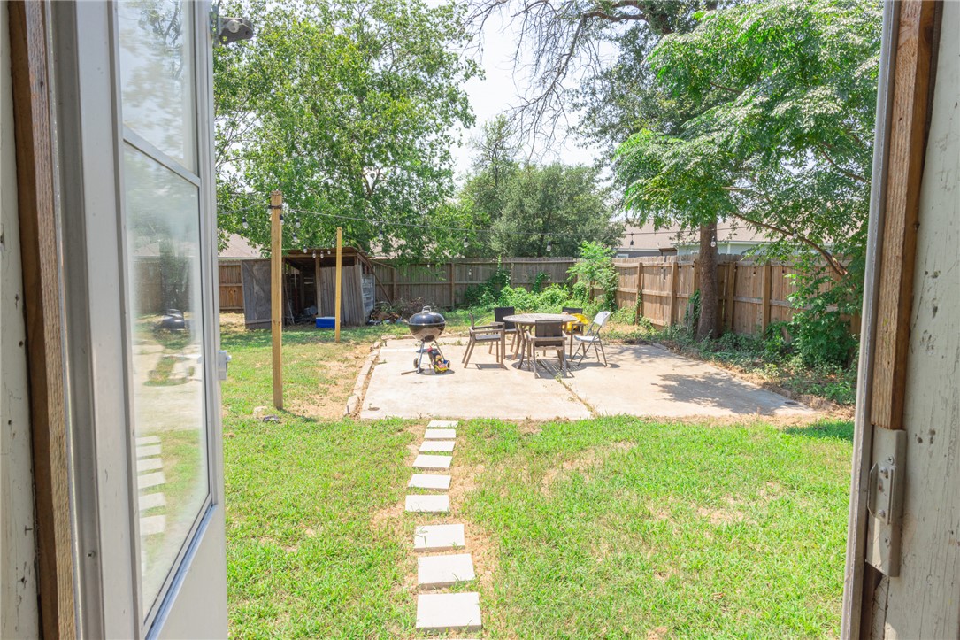 1902 Miller Avenue Bryan, TX 77801 - Photo 43 of 45 a view of a patio with table and chairs potted plants and large tree