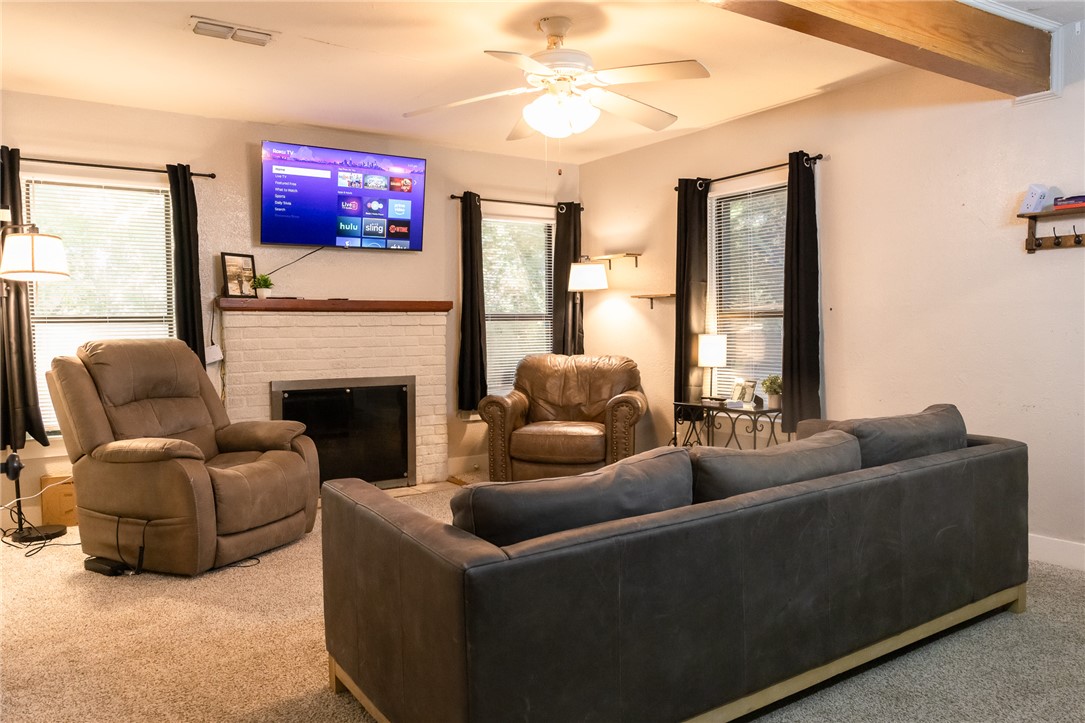 1902 Miller Avenue Bryan, TX 77801 - Photo 5 of 45 a living room with furniture a flat screen tv and a fireplace