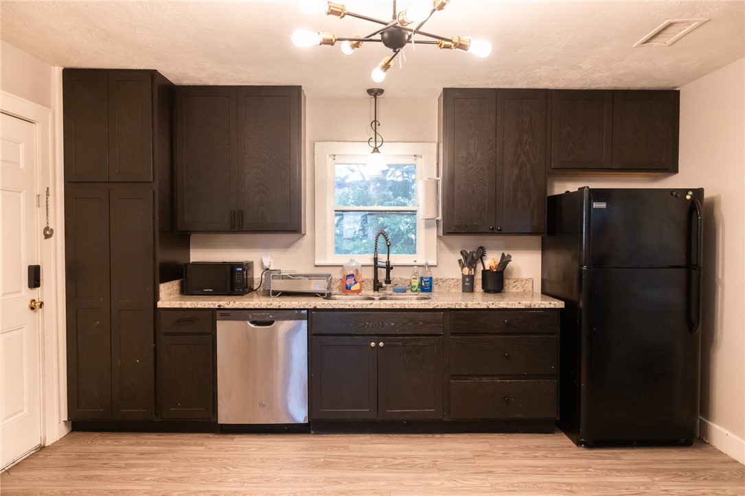 1902 Miller Avenue Bryan, TX 77801 - Photo 10 of 45 a kitchen with a sink a refrigerator and cabinets