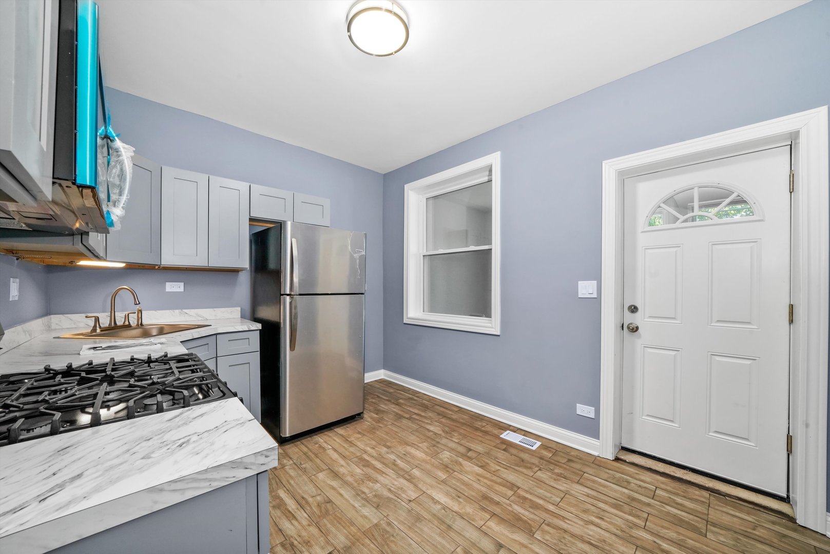 2906 North Harding Avenue Chicago, IL 60618 - Photo 14 of 29 a kitchen with a stove a refrigerator and a sink
