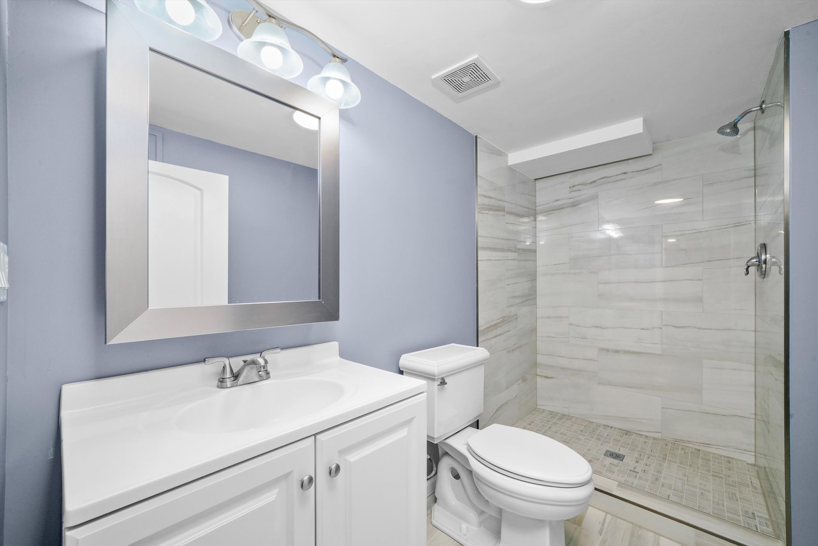 2906 North Harding Avenue Chicago, IL 60618 - Photo 19 of 29 a bathroom with a sink toilet vanity and shower