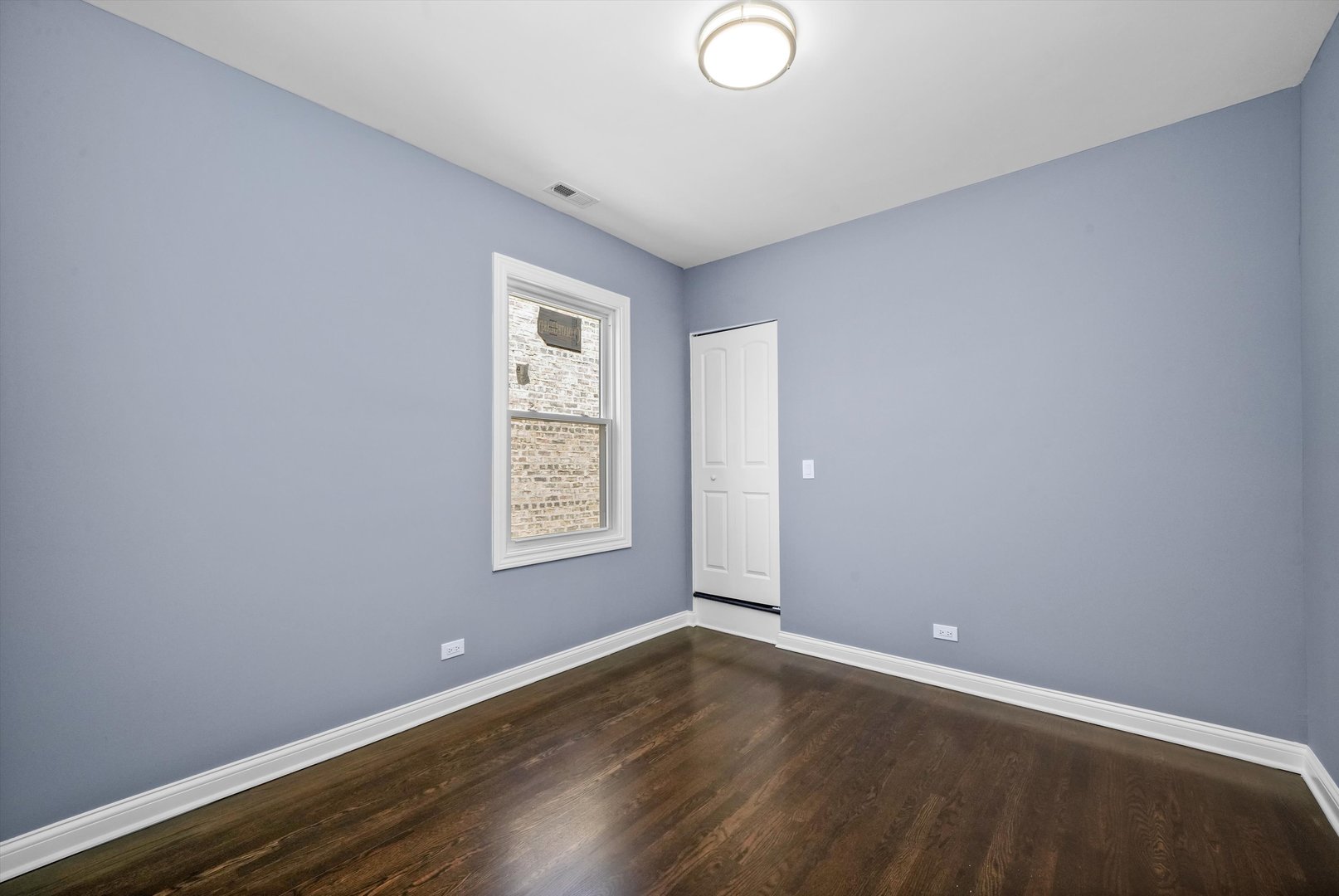 2906 North Harding Avenue Chicago, IL 60618 - Photo 27 of 29 an empty room with wooden floor and windows