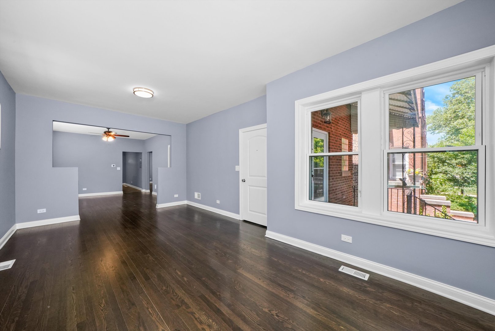 2906 North Harding Avenue Chicago, IL 60618 - Photo 5 of 29 a view of an empty room with wooden floor and a window