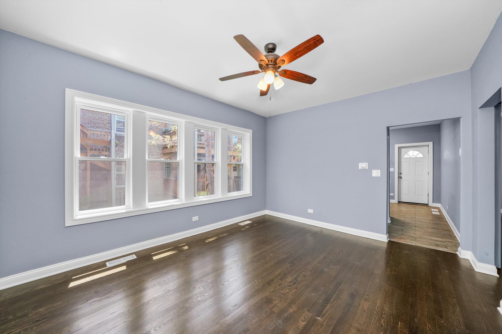2906 North Harding Avenue Chicago, IL 60618 - Photo 7 of 29 a view of an empty room with wooden floor and a window
