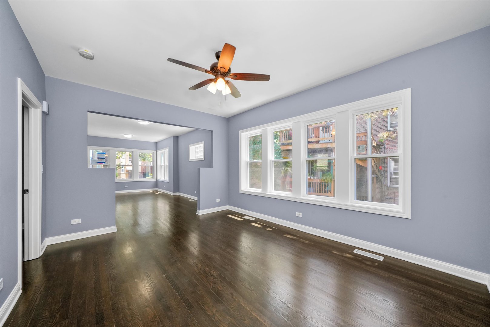 2906 North Harding Avenue Chicago, IL 60618 - Photo 8 of 29 a view of an empty room with wooden floor and a window