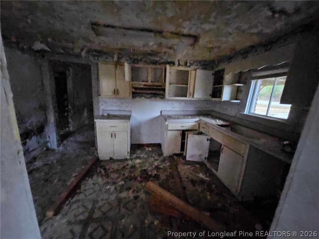 1737 West Carthage Road Lumberton, NC 28360 - Photo 21 of 39 a kitchen with a sink and cabinets