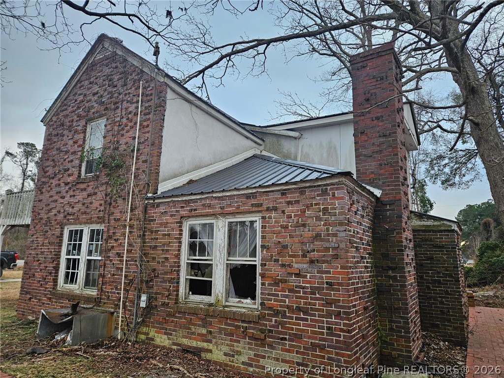 1737 West Carthage Road Lumberton, NC 28360 - Photo 35 of 39 a view of a brick house with a large tree and windows
