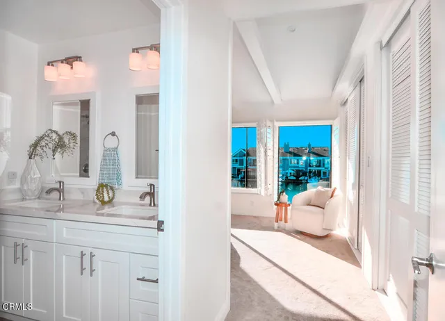 a bedroom with furniture and large windows