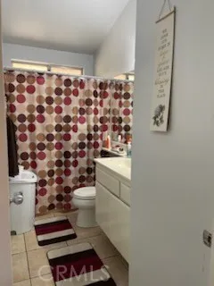 a bathroom with a toilet and a shower curtain